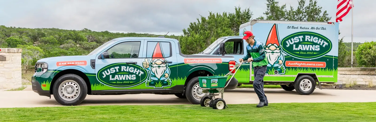 Just Right Lawns technician fertilizing lawn near company truck